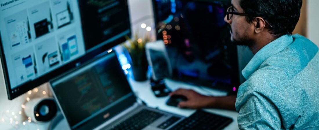 man in blue dress shirt using computer